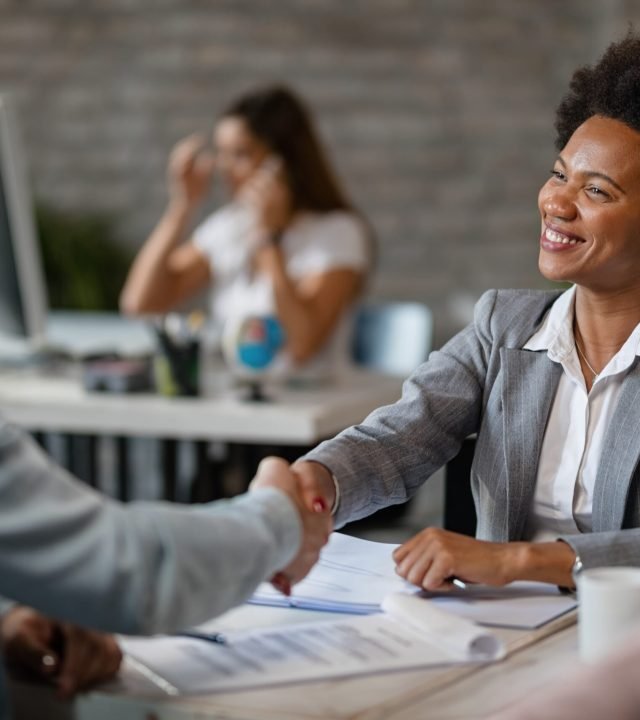 happy-african-american-bank-manager-shaking-hands-with-client-after-successful-agreement-office (1)